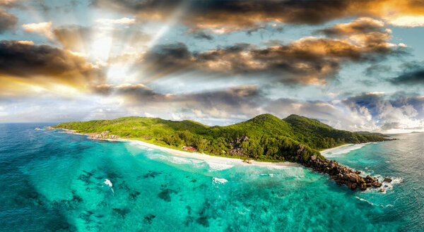 Panoramic sunset aerial view of La Digue Island in Seychelles, Grande and Petite Anse Beaches.