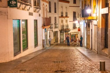 Cordoba, İspanya - 11 Nisan 2023: Geceleri şehir sokakları boyunca turistler.