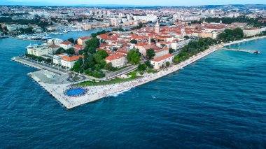 Zadar at sunset, Croatia. Aerial view of promenade with sea organ and greeting to the sun landmarks clipart