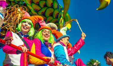 Viareggio, Italy - February 10, 2013: People with colorful costumes dancing on a Float at the famous Carnival parade.