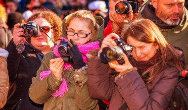 Venice, Italy - February 8, 2015: Crowd of phorographers taking pictures of people masks during the carnival parade.