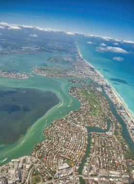 Amazing aerial view of Miami Beach skyline and coastline from a departing airplane.