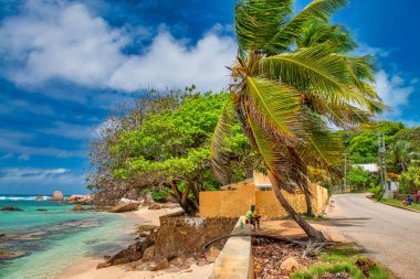 Praslin, Seychelles - September 2017: People along the beautiful beach on a sunny day.