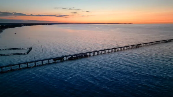 Aerial view of Busselton Jetty at sunset, Western Australia.
