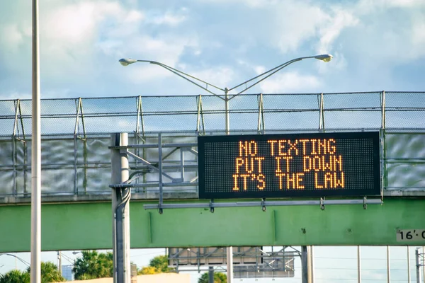 No Texting - It\'s the Law sign.