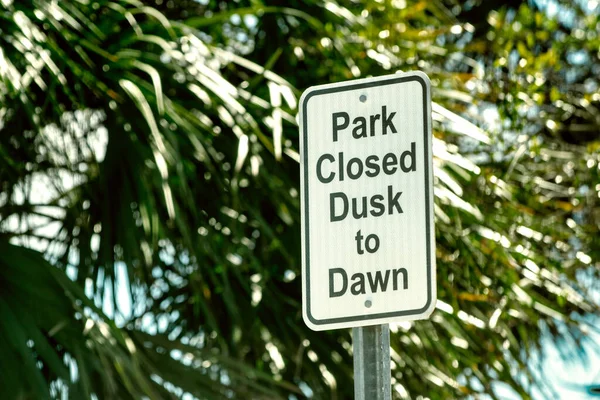Park closed Dusk to Dawn road sign.