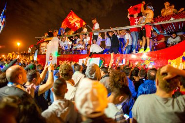 PISA, ITALY - JUNE 15TH, 2016: Local fans celebrate the soccer team's promotion. Celebrations in the night with smoke bombs and an open bus.