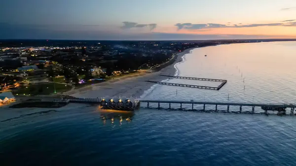 Aerial view of Busselton Jetty at sunset, Western Australia.