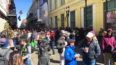 New Orleans, LA - February 9, 2016: Crowd of tourists and locals along the city streets for Mardi Gras event.