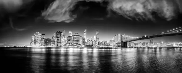 Downtown Manhattan night lights, panoramic view from Brooklyn Bridge Park.