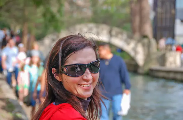 stock image San Antonio, Texas. Happy female tourist along the city river.