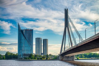 Riga, Latvia - July 7, 2017: Riga bridge and modern buildings on a sunny afternoon.