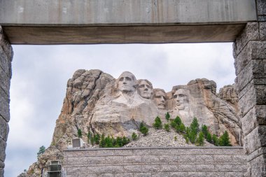 Mount Rushmore National Monumet framed by park entrance gate. clipart