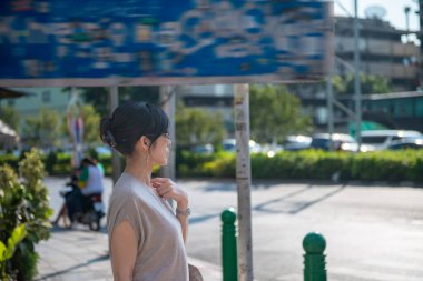 Bangkok, Thailand - December 14, 2019: A beautiful thailand female walking outdoor in the city outskirts.