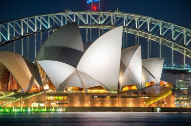 Sydney Harbour Bridge and Opera House Glowing in Evening Blue Hour. clipart