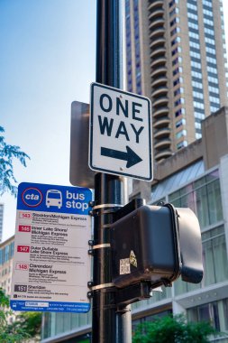 Chicago, IL - July 25, 2024: Ytaffic signs and bus schedule along Magnificent Mile. clipart