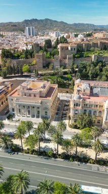 Stunning aerial view of Malaga with coastline, cityscape, and mountains in the background. clipart