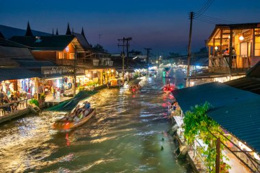 Amphawa, Tayland - 15 Aralık 2019: Tayland 'da aydınlatılmış nehir kenarı dükkanları ve canlı atmosferli Amphawa Yüzen Pazarı Gece Görüşü.