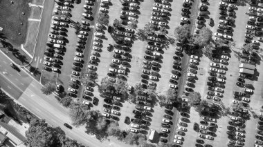 Aerial view of an full car parking along a mall center.