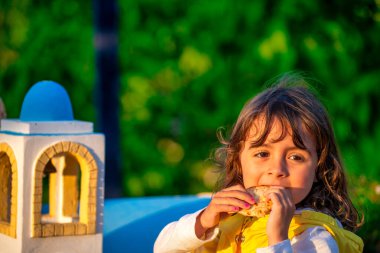 Mutlu genç kız, alacakaranlıkta manzaralı bir adada küçük bir ev kopyasıyla oynuyor..