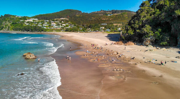 Aerial shot of Hot Water Beach golden sands and geothermal pools in New Zealand. 