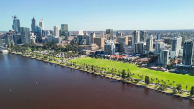 Perth gökyüzü açık mavi gökyüzü ve güneşli gün yansımaları ile Kuğu Nehri 'nden ufuk çizgisi.