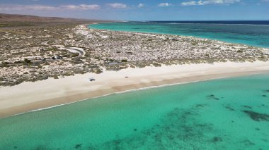 Exmouth 'taki Turkuaz Sahili' nin insansız hava aracı görüntüleri beyaz kum ve turkuaz okyanusu gösteriyor..