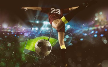 Futbol oyuncusu, cep telefonu ve top stadyumda.