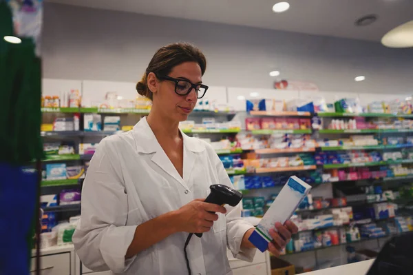 Pharmacist woman works at the pharmacy counter