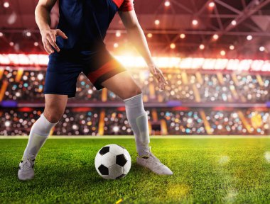 Football player ready to kick the soccerball at stadium