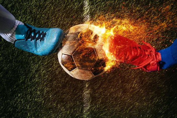 Two opposing players in front of the burning soccer ball