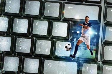 Football player exits from a laptop keyboard as soccer streaming concept