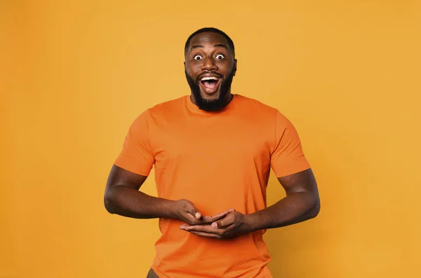 Happy Afro Man Holds Something Orange Background — Stockfoto