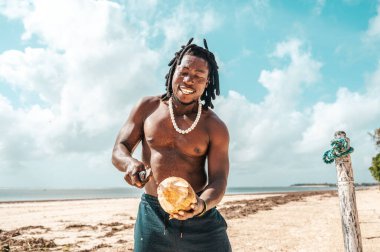 Kenyan people with coconut at the beach in typical clothes