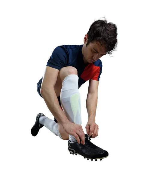 stock image Soccer player ties his shoes ready to play