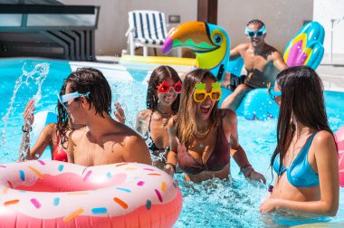 Group of friend play together in the pool