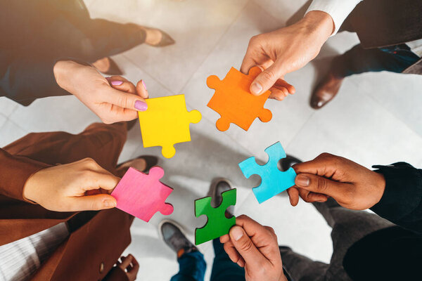 Business people connect puzzle pieces as integration and startup