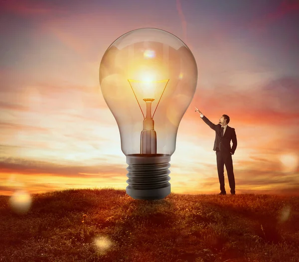Businessman Indicates Big Light Bulb Idea Concept — Stock Photo, Image