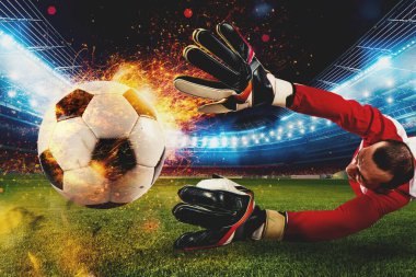 Futbol stadyumunda ateşli bir topla güçlü bir futbolcu vuruşu.