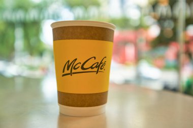SINGAPORE - 19 HAZİRAN 2020: Singapur 'daki McDonald' s restoranındaki bir masada McCafe marka kağıt bardağı yakın çekim.