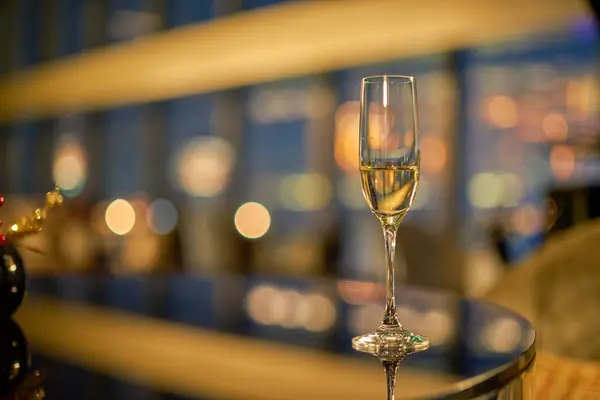 Close up shot of glass of champagne served on table at night.