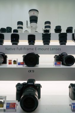 COLOGNE, GERMANY - CIRCA SEPTEMBER, 2018: Sony digital cameras and lens on display seen at Photokina Exhibition. Photokina is a trade fair held in Europe for the photographic and imaging industries. clipart