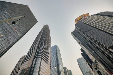 SHENZHEN, CHINA - 27 NOVEMBER, 2019: up view from ground in Shenzhen downtown during civil twilight. clipart