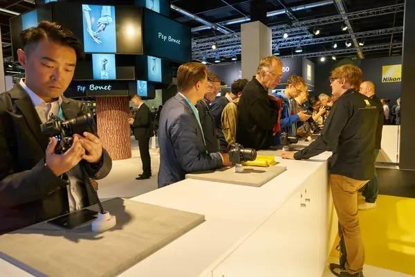 stock image COLOGNE, GERMANY - CIRCA SEPTEMBER, 2018: visitors to try cameras in Nikon space at Photokina Exhibition. Photokina is a trade fair held in Europe for the photographic and imaging industries.