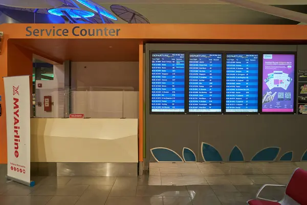 stock image KUALA LUMPUR, MALAYSIA - CIRCA MARCH, 2023: service counter and flight information display system seen in Kuala Lumpur International Airport.