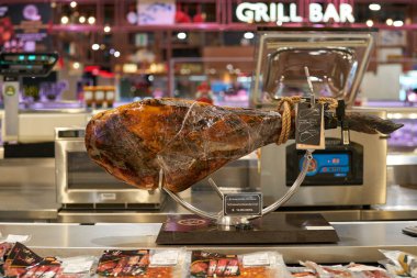 BANGKOK, THAILAND - CIRCA APRIL, 2023: 5J acorn fed ham with bone on display Tops Food Hall premium-level supermarket in CentralWorld shopping center in Bangkok.  clipart