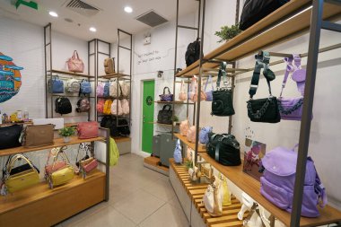 HO CHI MINH CITY, VIETNAM - CIRCA MARCH, 2023: interior shot of Kipling retail store in Crescent Mall. Kipling is a brand selling handbags, backpacks, totes, luggage and other accessories. clipart