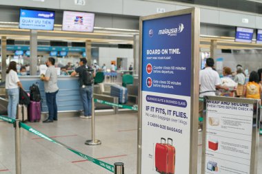 HO CHI MINH CITY, VIETNAM - CIRCA MARCH, 2023: passengers stand in line at Malaysia Airlines check-in area in Tan Son Nhat International Airport.