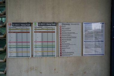 KUALA LUMPUR, MALAYSIA -  MAY 26, 2023: operating schedule and prohibition signs as seen at BBCC - Hang Tuah station in Kuala Lumpur. clipart