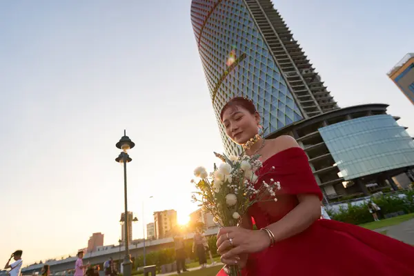 stock image HO CHI MINH CITY, VIETNAM - MARCH 25, 2023: outdoor photo of woman in red dress in the area of Bach Dang Wharf.